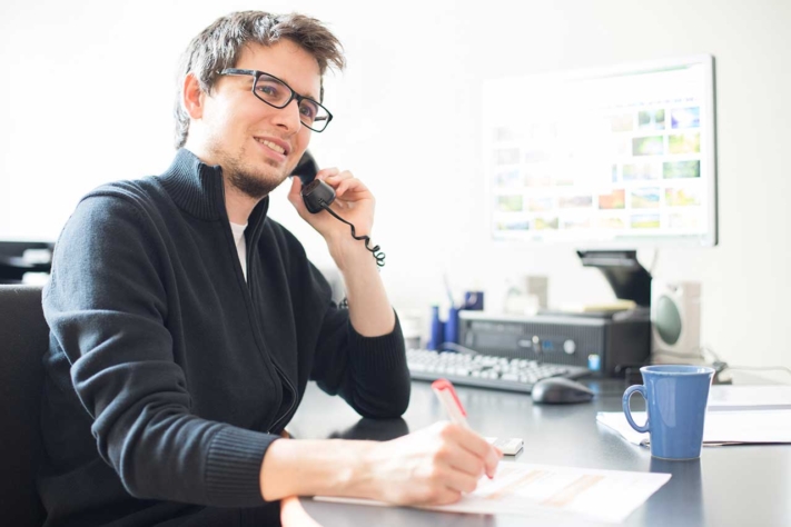 Sales representative makes a phone call to the potential customer as part of his offer management.