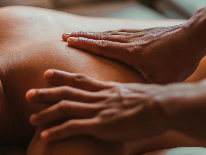 Hands massaging a back