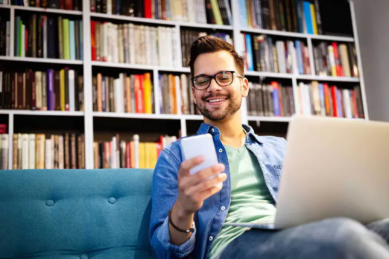 Man catalogs his books in book app.