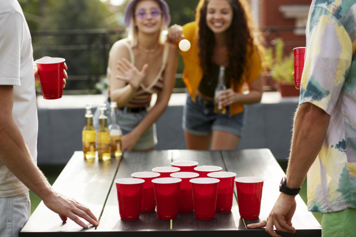 Friends play beer pong together