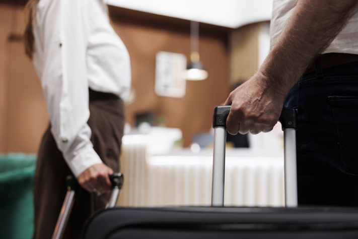 Business trip: Hand on the suitcase
