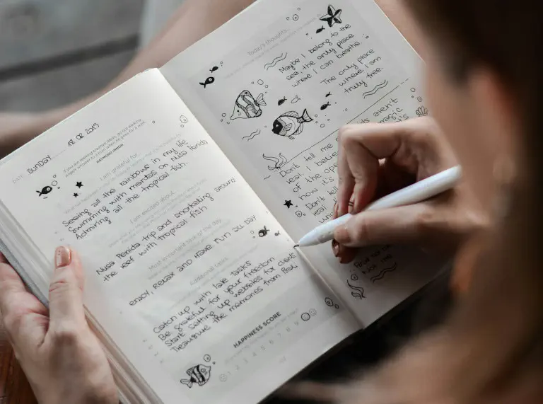 Woman designing an analog travel diary